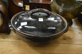 A large earthenware bowl and cover.