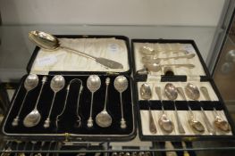 A cased set of six silver coffee spoons with sugar tongs and various other silver flatware and