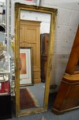 A gilt framed dressing mirror.