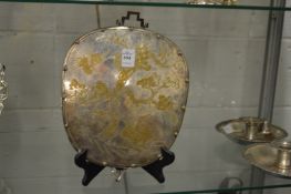 A Chinese mirror with engraved silver plated frame.