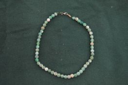 A jadeite bead necklace.