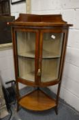 An Edwardian inlaid mahogany standing bow front corner cabinet.