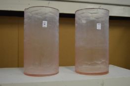 A pair of large frosted pink glass vases.