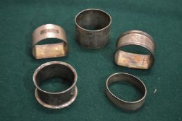 Five silver napkin rings.