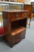 A small mahogany bow fronted cupboard.