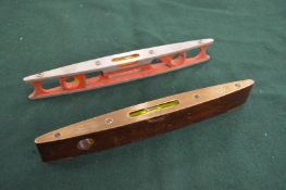 A Rabone brass and rosewood spirit level and another spirit level.