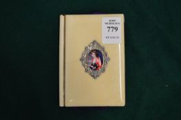 An ivory mounted purse decorated with a small enamel.