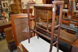 A towel rail, a corner cupboard and armchair.
