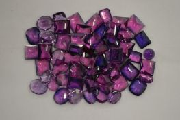 A box of kunzite and amethyst stones.