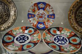 An Imari wavy edge dish and a pair of similar dishes.