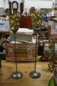 A pair of decorative metal candle stands.
