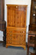 A yew wood serpentine fronted cabinet.