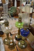 Three oil lamps and a candle stand.