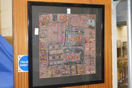 An eastern textile, framed and glazed.