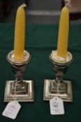 A pair of silver dwarf candlesticks.