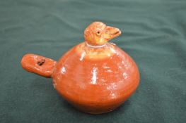 A small terracotta folk art bird form whistle.