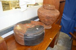 A leather footstool and a wicker Ali Baba laundry basket.
