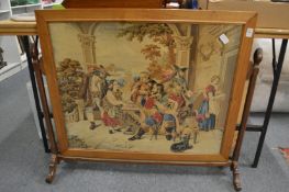 An embroidered tapestry picture mounted as a fire screen.