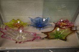 Five large colourful art glass dishes.