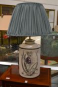 A good decorative table lamp modelled as painted tea canister.