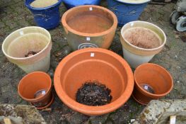 Seven various terracotta garden planters.