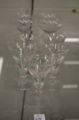A set of four slender glasses decorated with cockfighting scenes together with a set of five conical