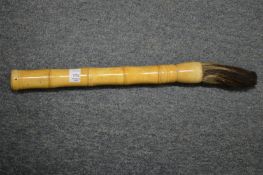 A Chinese bone handled brush.