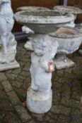 A cherub birdbath.