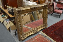 A large decorative gilt framed mirror.