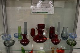 A small collection of stylish glassware to include ruby tinted glass jugs, vases and small bubble