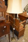 A brass standard lamp and a sewing trolley.