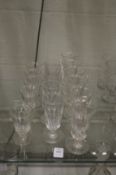 A set of six facet cut conical cut wine glasses together with a set of five similar and five smaller