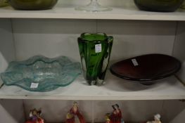 A heavy lobed green glass vase, a turquoise wavy rimmed dish and a ruby glass oval dish.