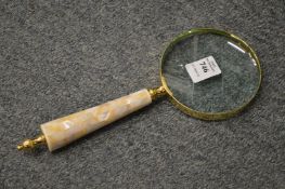 A magnifying glass with mother-of-pearl handle.