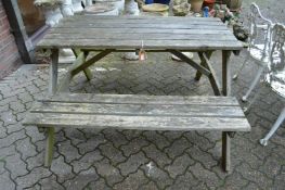 A pine picnic table with bench seat.