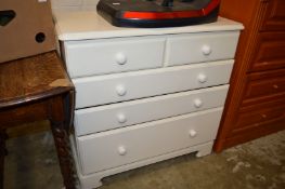 A cream painted bedroom chest.