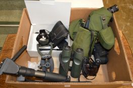 A spotting scope, a pair of Swarovski binoculars and similar equipment.
