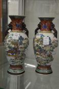 A pair of Chinese twin handled baluster shaped vases.