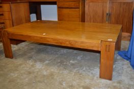A large unusual teak coffee table.