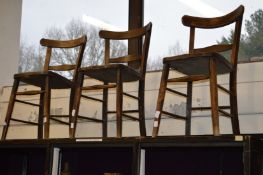 Three old kitchen chairs.