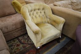 A button upholstered tub shaped armchair on cabriole legs.