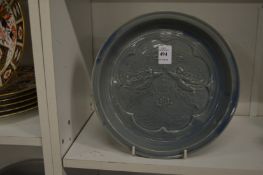 A Chinese circular dish with moulded decoration.