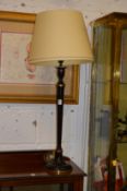 A decorative candlestick style table lamp.