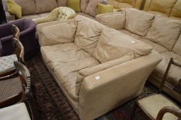 A tan leather upholstered two seater settee.