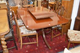 A good large mahogany twin pedestal extending dining table with one leaf.