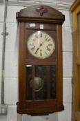 An oak cased drop dial wall clock.