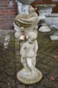 A figural bird bath.