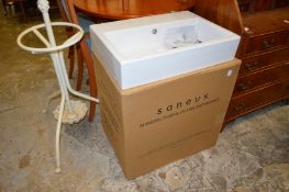 A rectangular porcelain sink together with the matching two drawer white lacquer vanity unit (