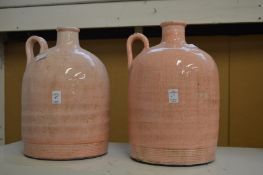 Two large pink glazed flagons.