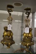 A pair of Chinese cast bronze figural candle stands.
